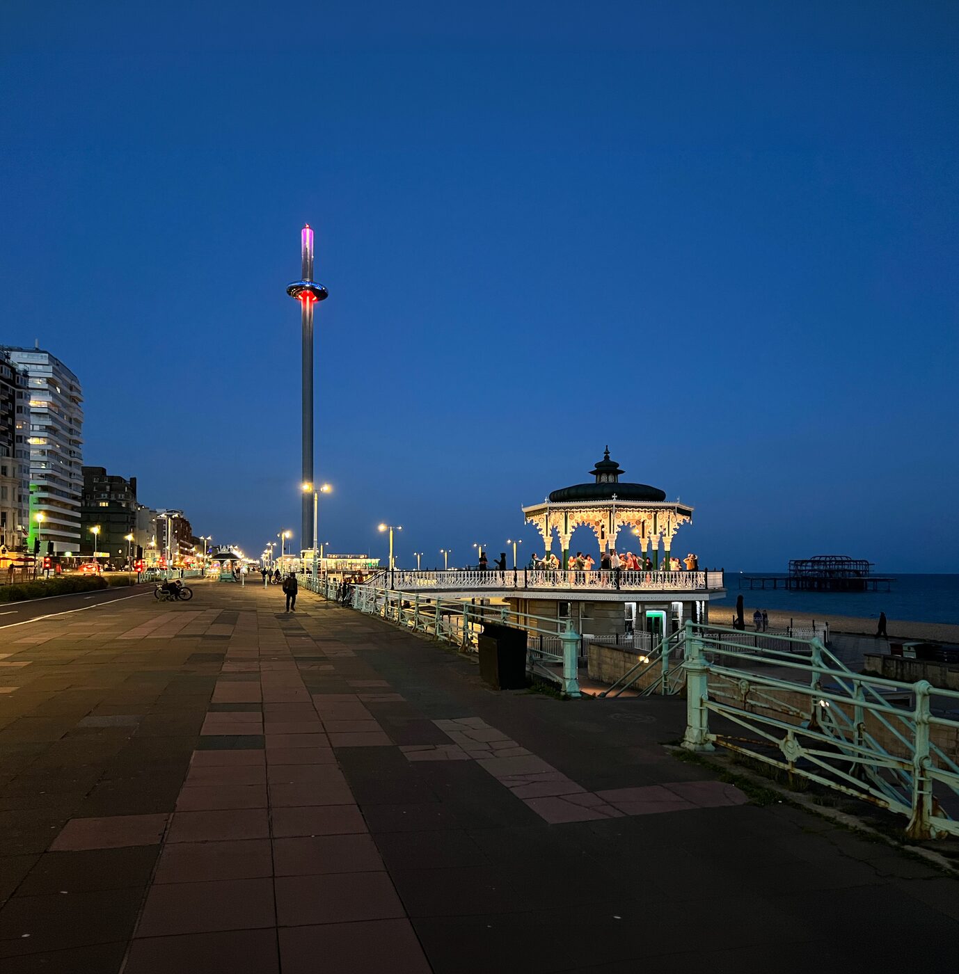 Brighton seafront at night with the i360 and bandstand illuminated