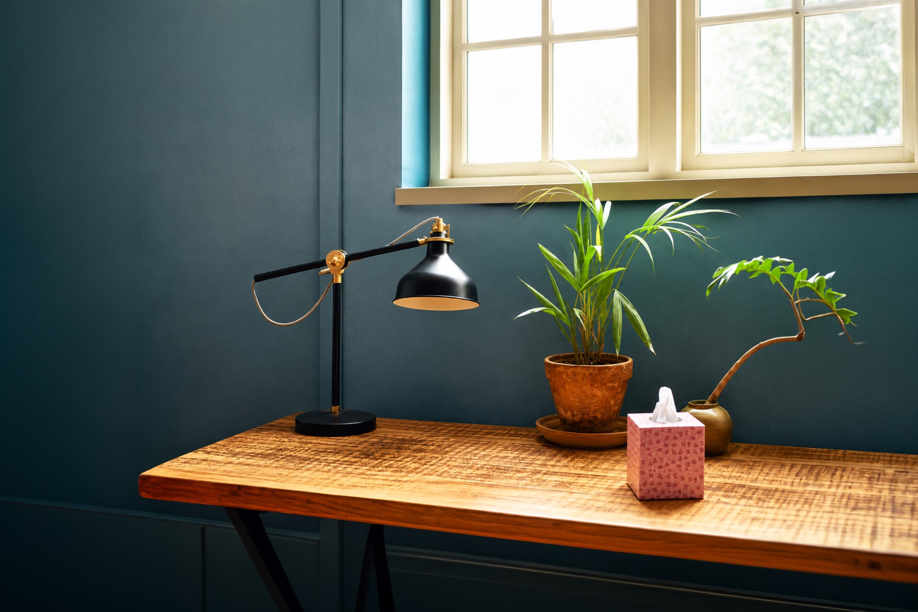 A calm New Road room with a wooden desk, reading lamp and plants