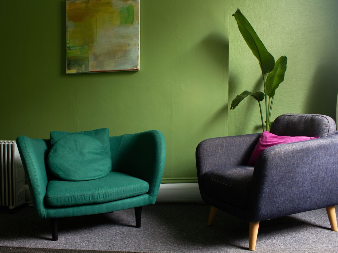 A warm room with a leather sofa and mustard armchair