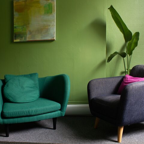 Green room with colourful armchairs